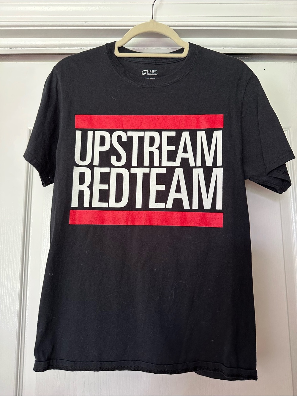Port and Company Black Tee with Red and White UPSTREAM REDTEAM Graphic